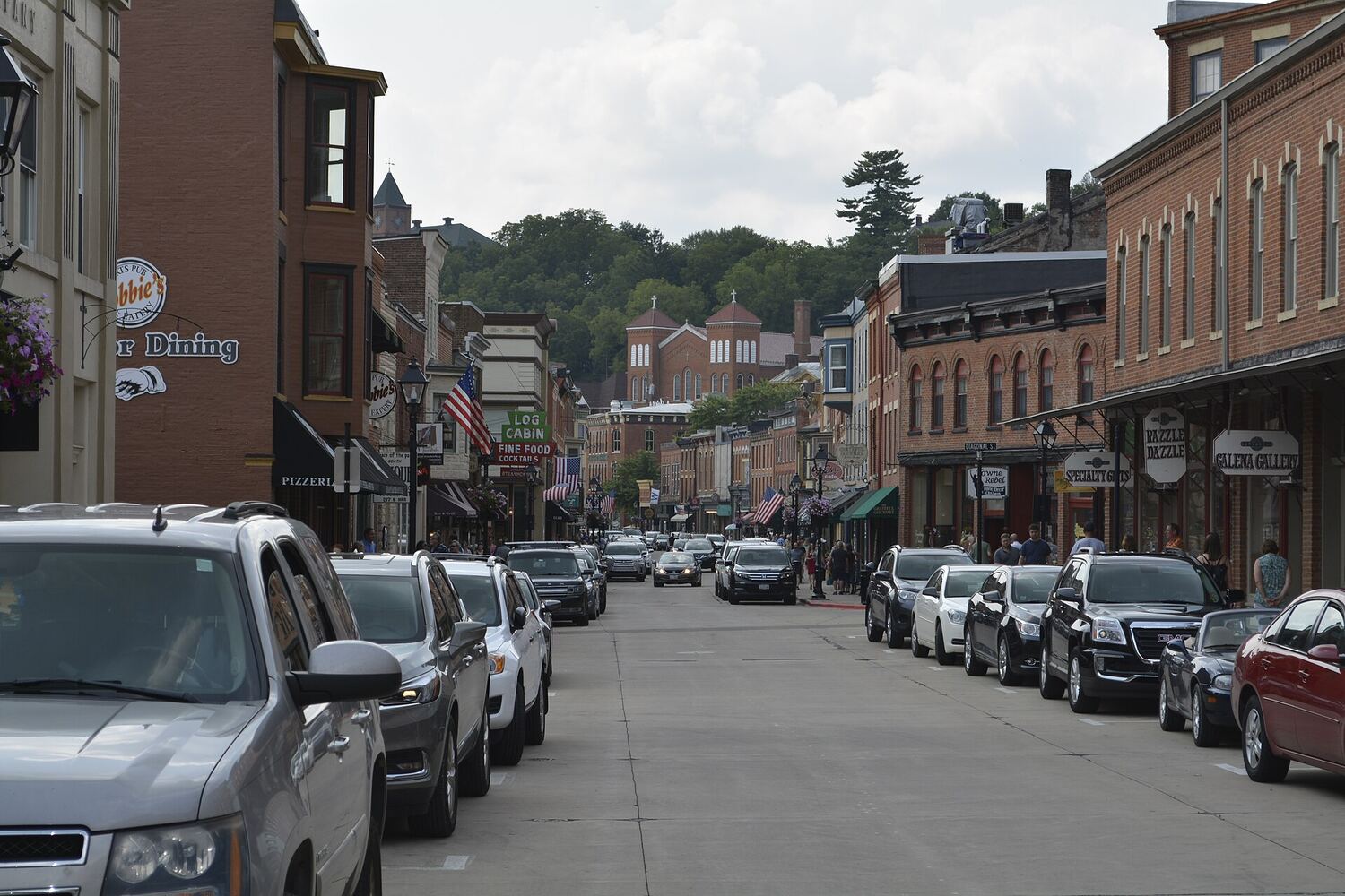 A brick-lined small-town main street full of local shops